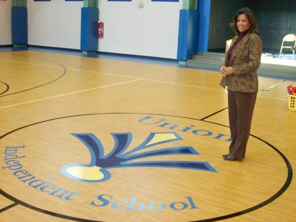 Martina Hicks stands in UIS’s multipurpose room. In addition to using it for fitness programs for students, the school plans to rent the space to groups to generate revenue.