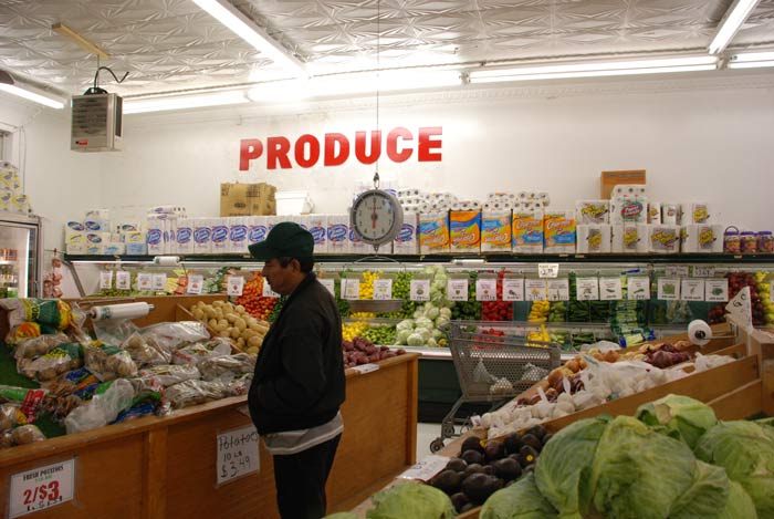 A shopper inspects the potatoes at Los Primos Supermarket on East Main Street. (Staff photo by Catherine Rierson)